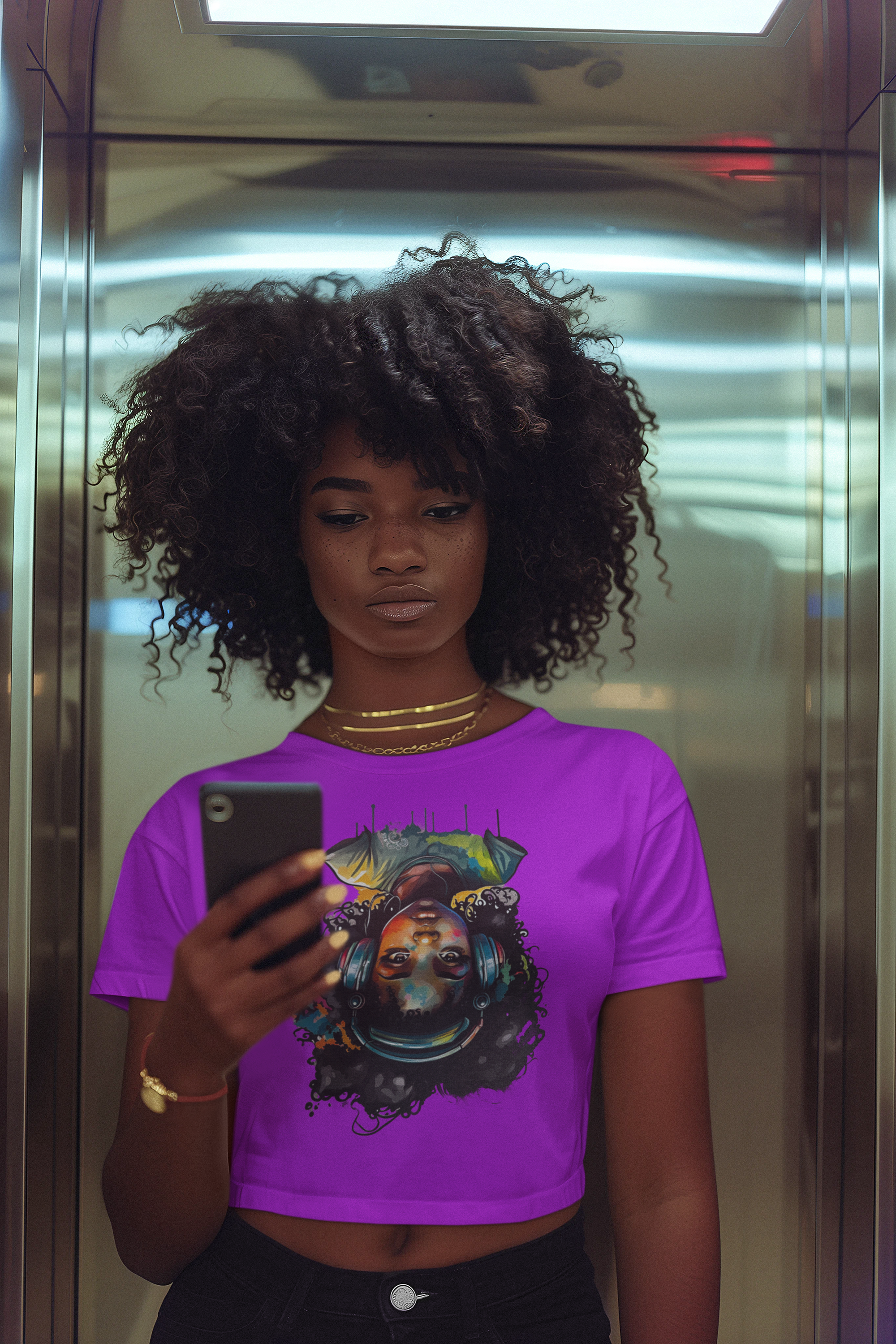 Person wearing a purple shirt with a graphic design, standing in an elevator.