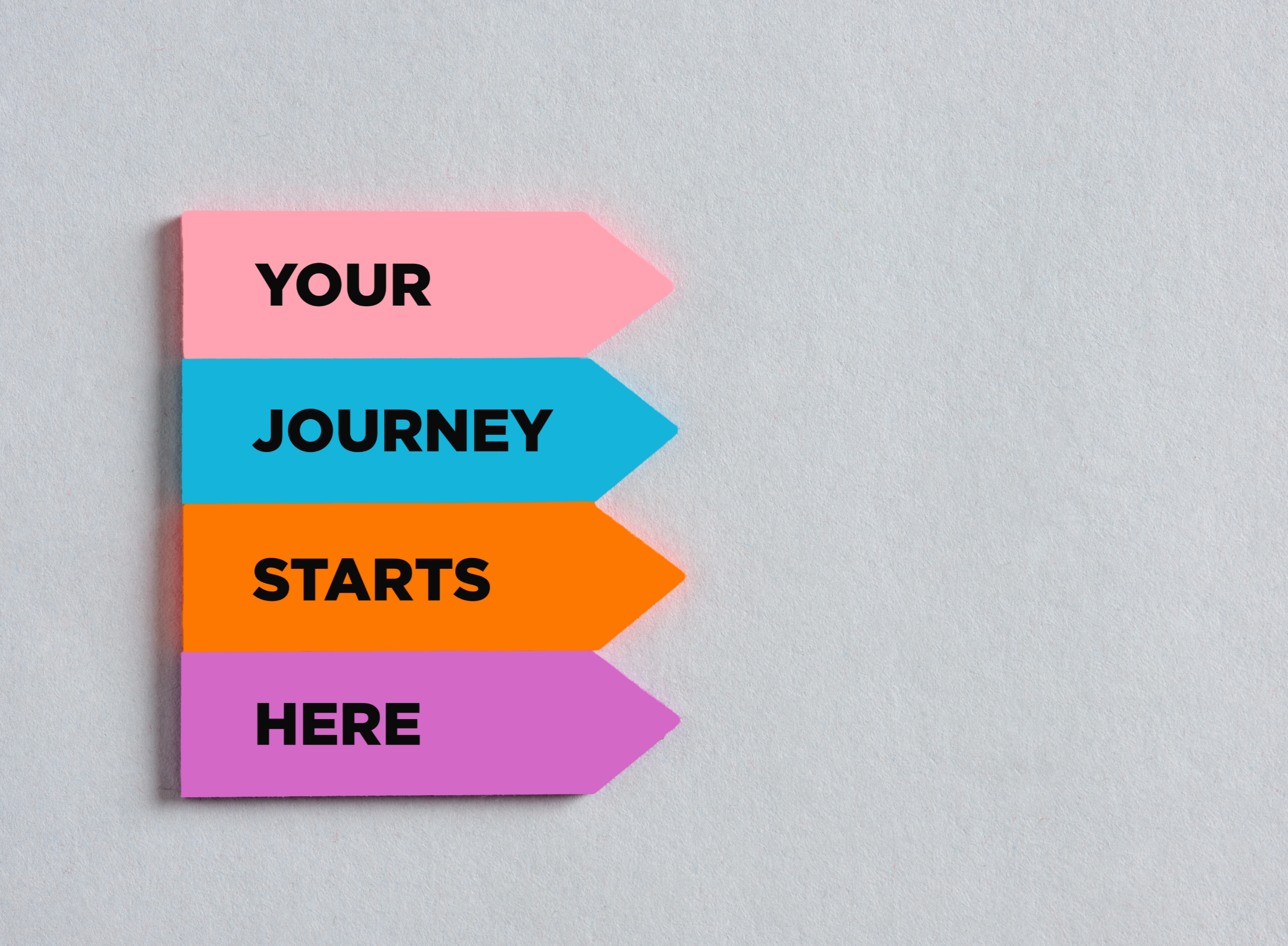 Colorful arrow-shaped signs with motivational text on a light gray background