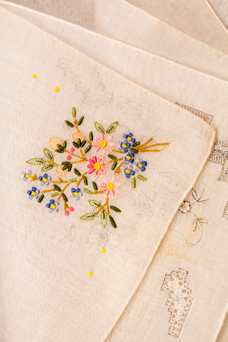Embroidered floral design on a beige fabric background